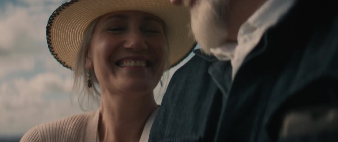 A woman and man are smiling and talking then they kiss