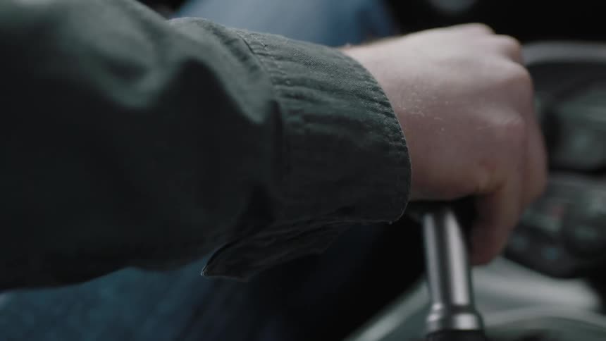 Close up of a man's hand shifting gears in a car