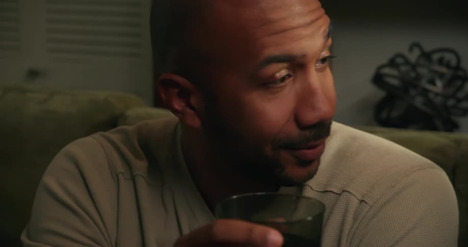 A man toasts a drink and talks