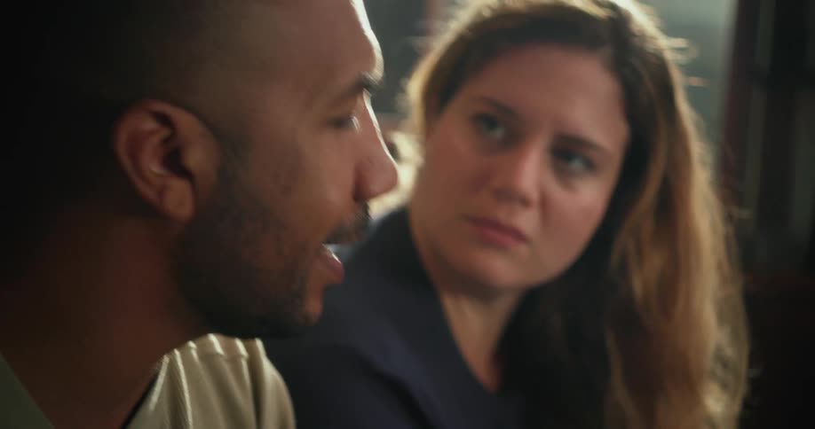 A couple sitting talking and arguing