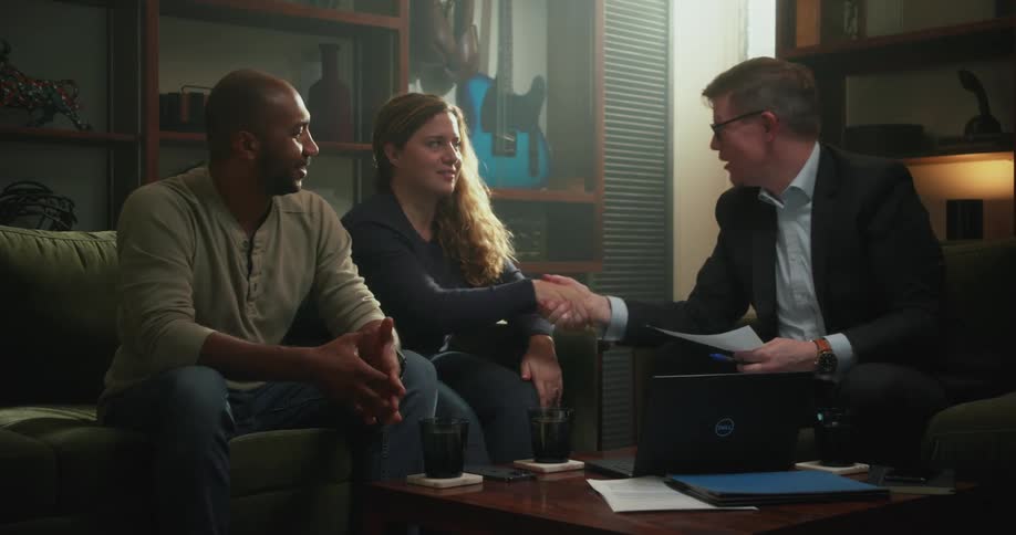 Three people are hanging out and shaking hands