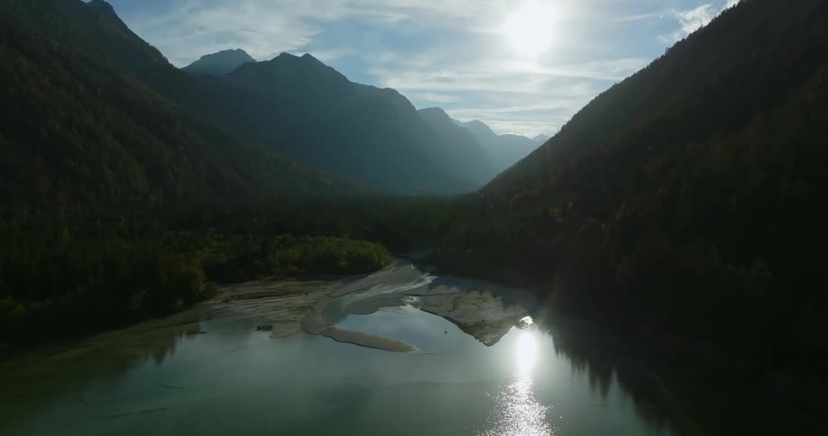 Aerial view of lake between forest mountains