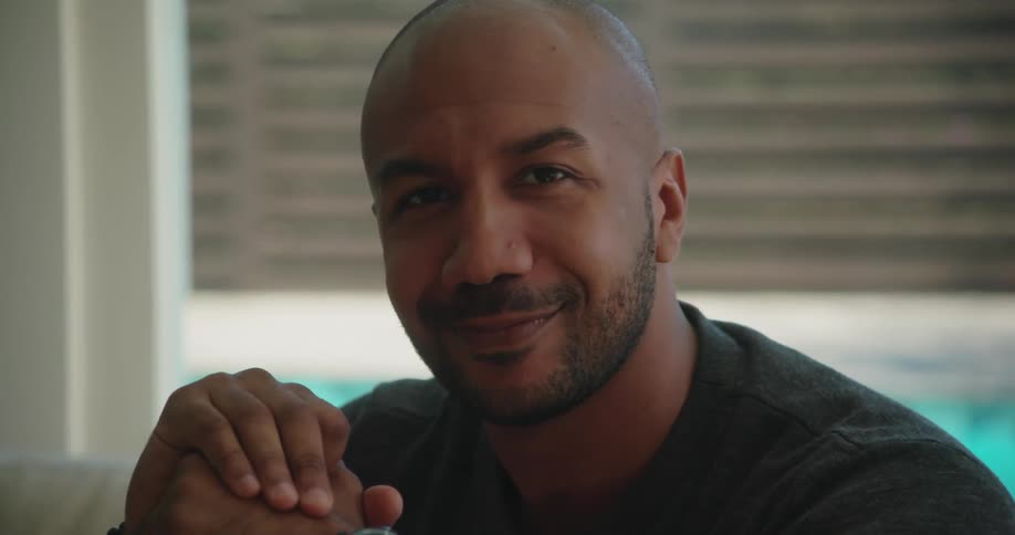 A man shakes his head and smiles