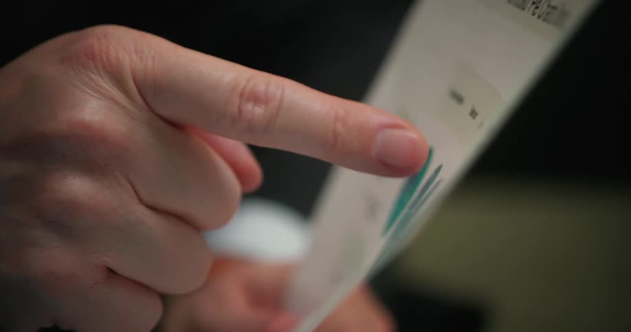Closeup of mans hand pointing on portfolio paper