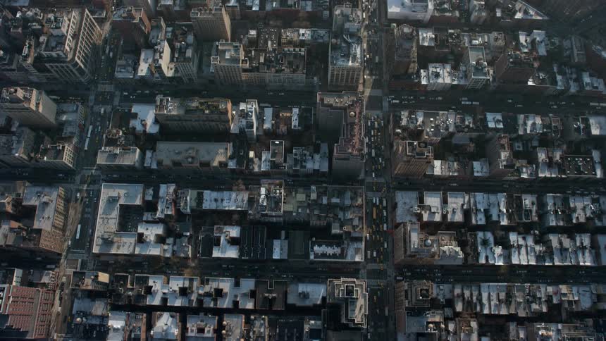 A stunning birds-eye view of heavy traffic on 7th Avenue leading to Greenwich Village during a sunny winter day in New York City
