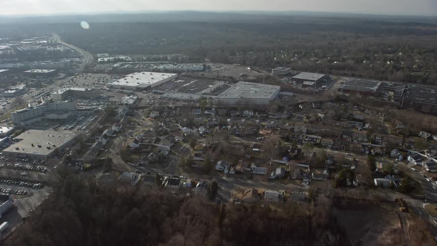 Aerial view of a suburban neighborhood and big box retail stores in Syosset Long Island during winter
