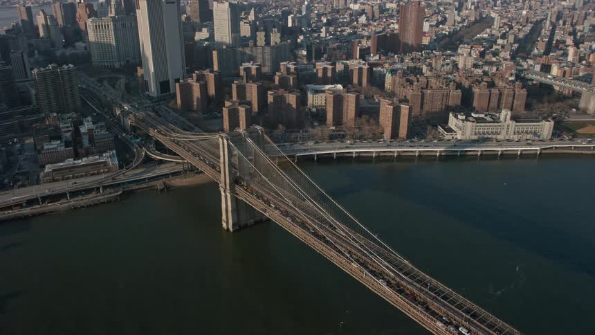 Aerial footage of heavy traffic crossing Brooklyn Bridge in New York City during winter