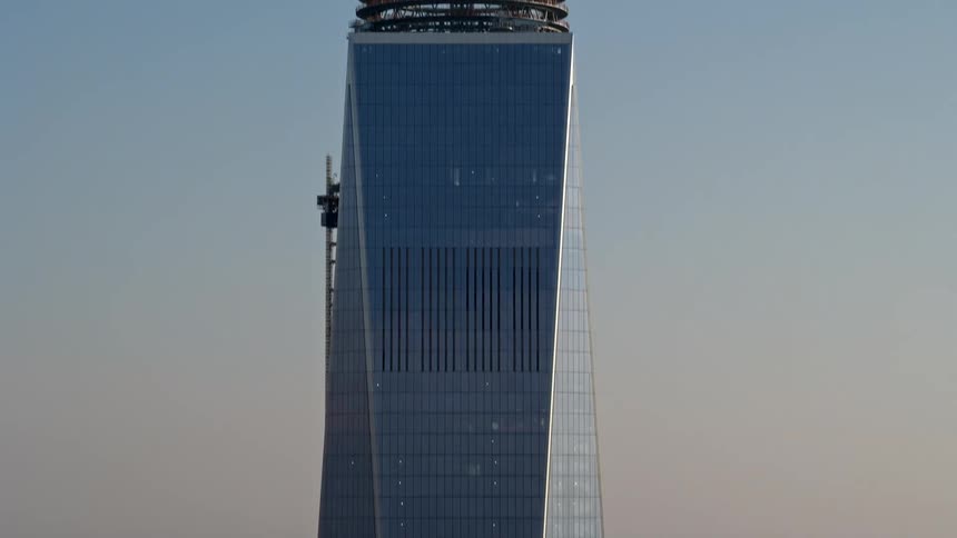 A breathtaking 4K aerial footage of the iconic Freedom Tower and Lower Manhattan skyline during a hazy winter day captured in an orbit and tilt movement that showcases the towering supertalls and modern buildings