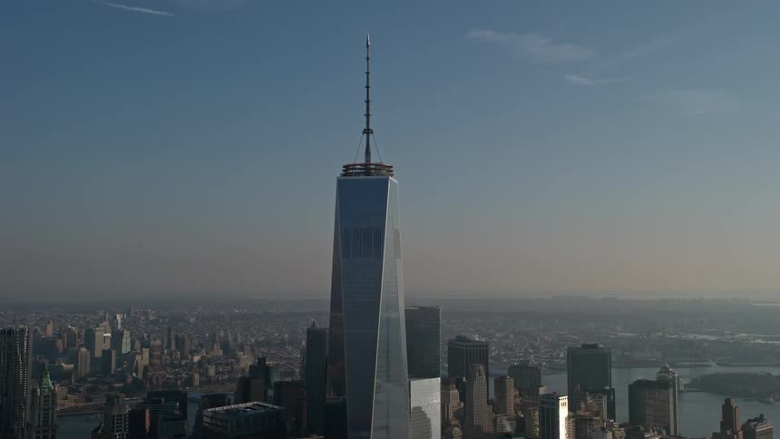 Aerial view of One World Trade Center standing tall above other skyscrapers on a hazy winter day in lower Manhattan New York City