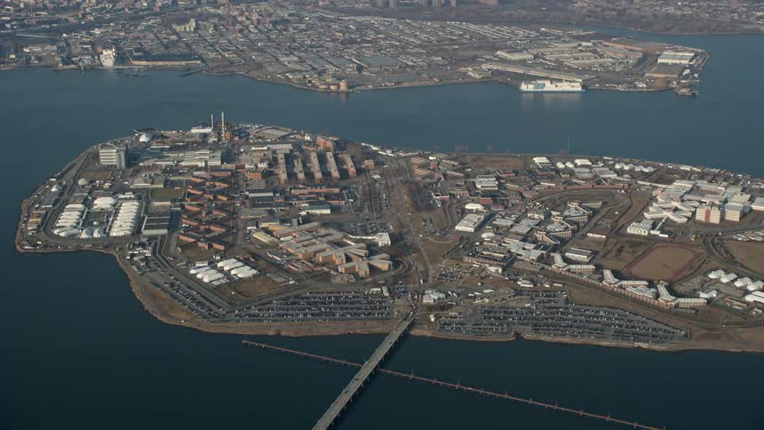 Aerial footage of Rikers Island prison during winter in New York City captured from a side view