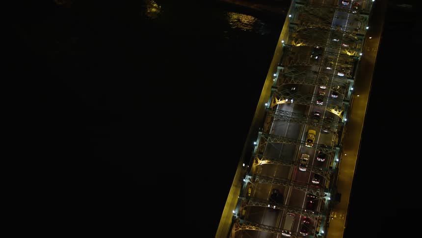 Cars slowly traverse the Queensboro Bridge on a winters night in New York City