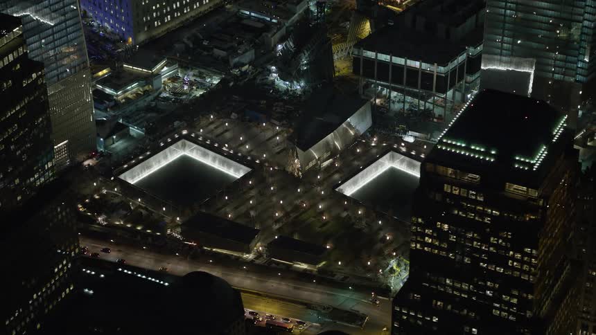 A 4K aerial view of the World Trade Center Memorial in Lower Manhattan New York City during a clear winter night