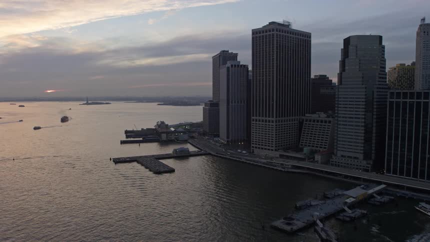 Aerial video footage of skyscrapers piers and the riverfront in lower Manhattan New York City during winter twilight