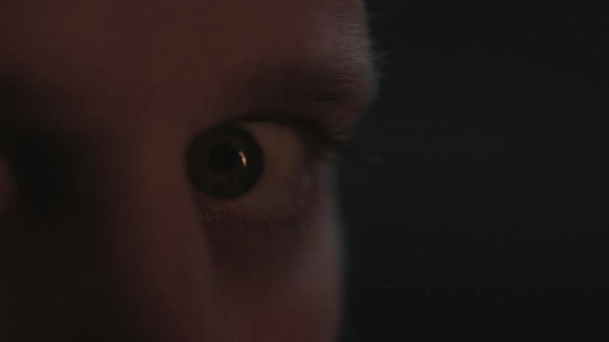 A person looks at the camera in a panicked manner