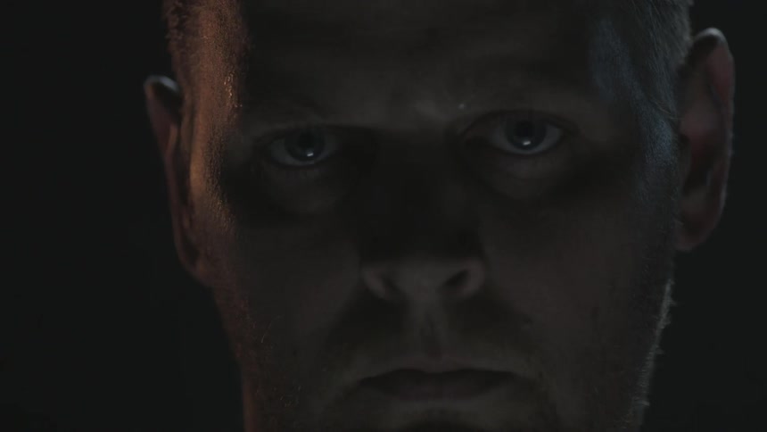 A man with his eyes closed opens them