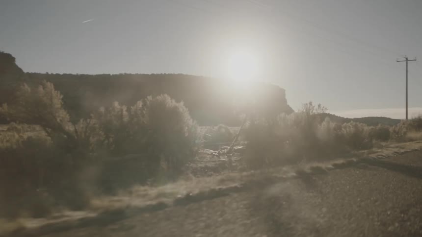 Sand flies down a road as it is passed
