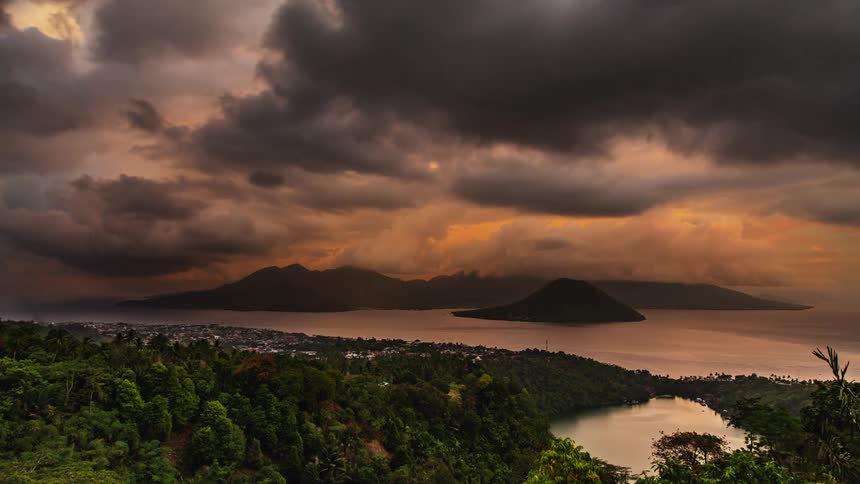 A time lapse of a coastal area shows billowing clouds churning overhead