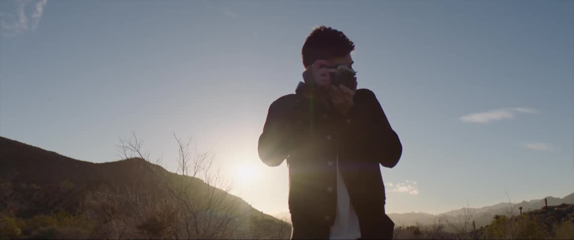 A man using a camera outdoors