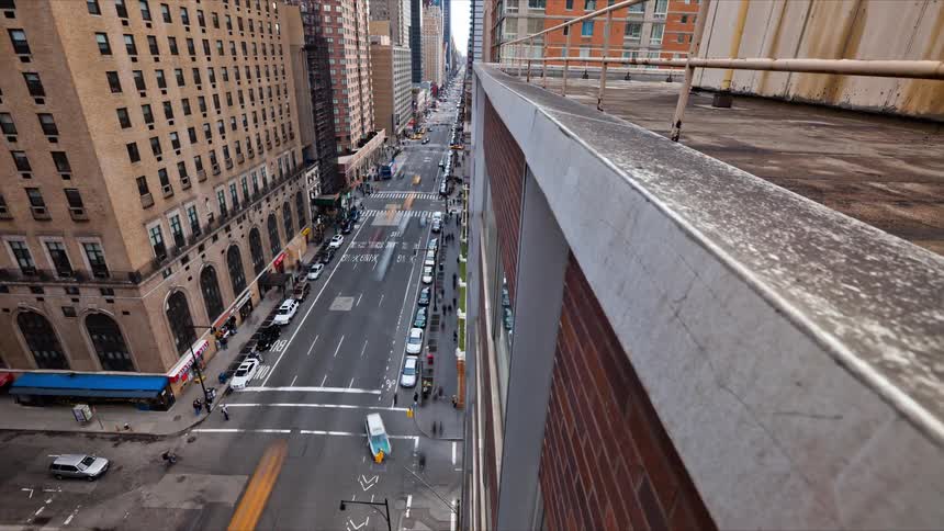 The view is of the downtown city and cars are driving on the high way