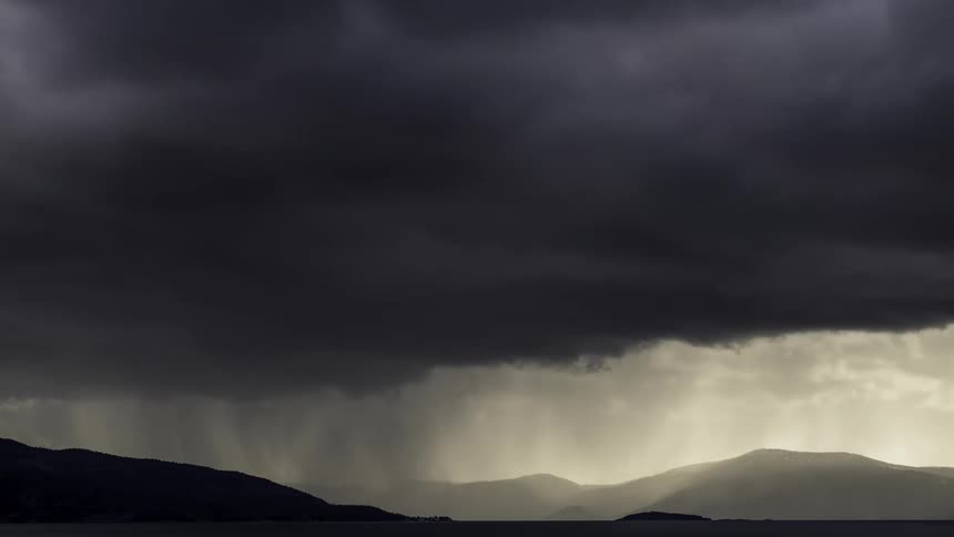Dark storm clouds move over the mountains