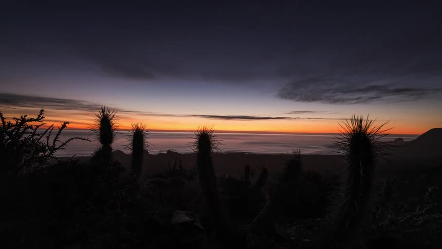 The sun sets along the coast