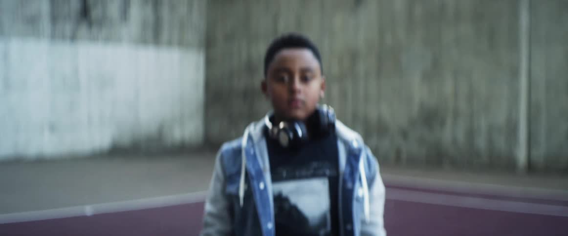 A boy riding a hoverboard comes to a stop