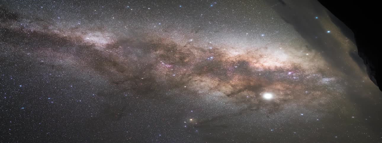 Dark clouds move over bright stars in the sky