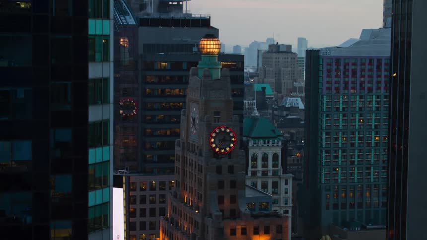 City with a large clock in the center of the buildings