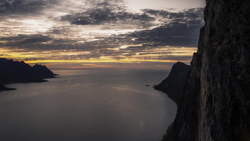 Aerial view of sunrise from bay near a cliff ridge