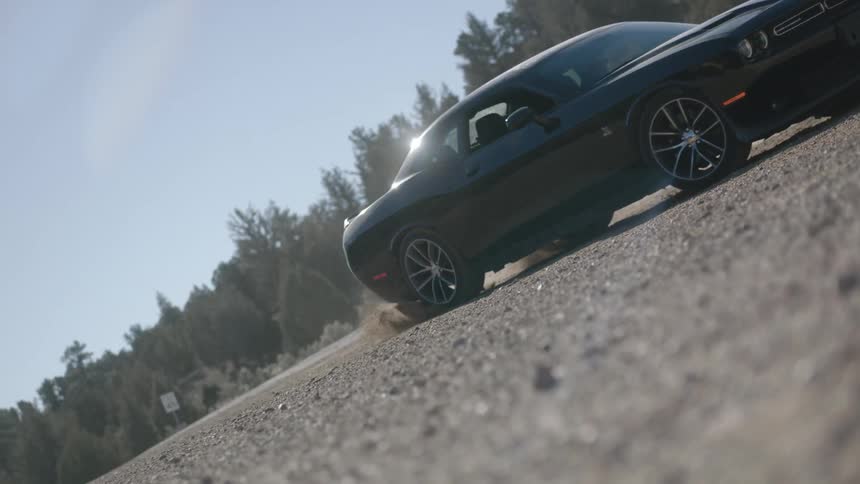 A car is doing doughnuts in a field