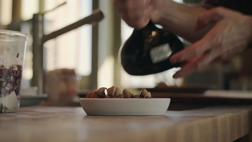 A man is preparing food for himself during the daytime
