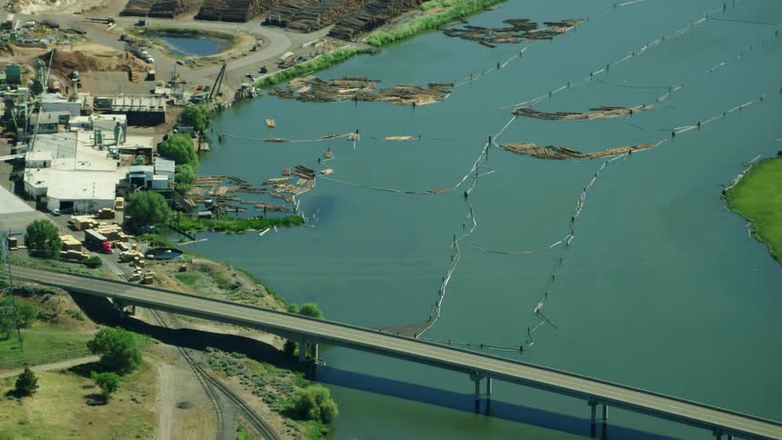 Aerial shot of a sawmill and floating log staging area on the Klamath River in rural Oregon