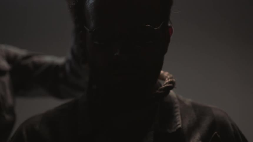 A noose is placed around a man's neck