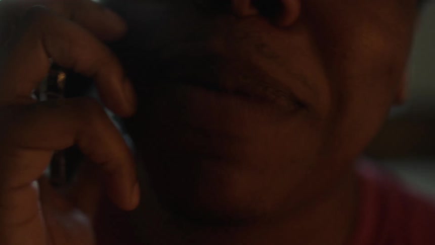 Closeup of mans mouth talking on smartphone