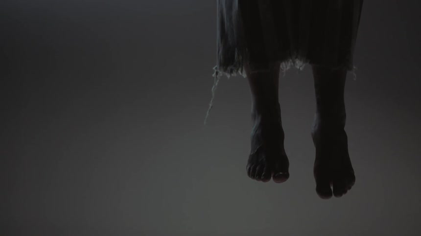 A person is hanging in a dark area