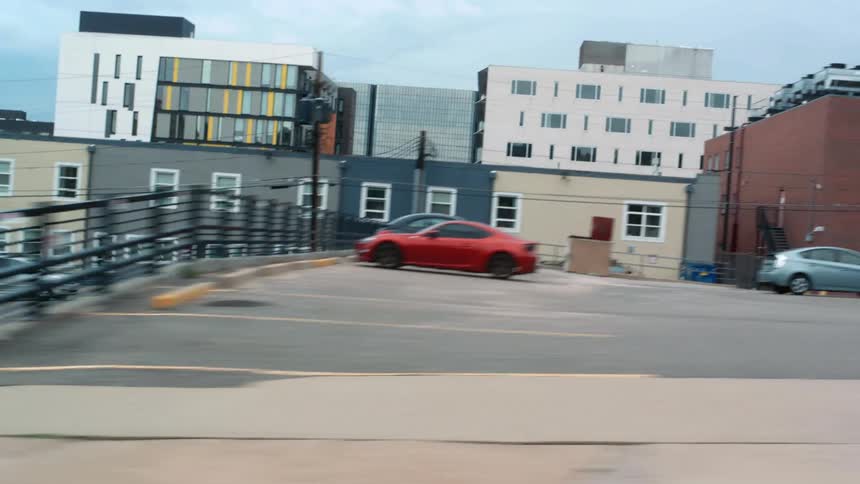 Buildings and cars in a city is displayed during the day time