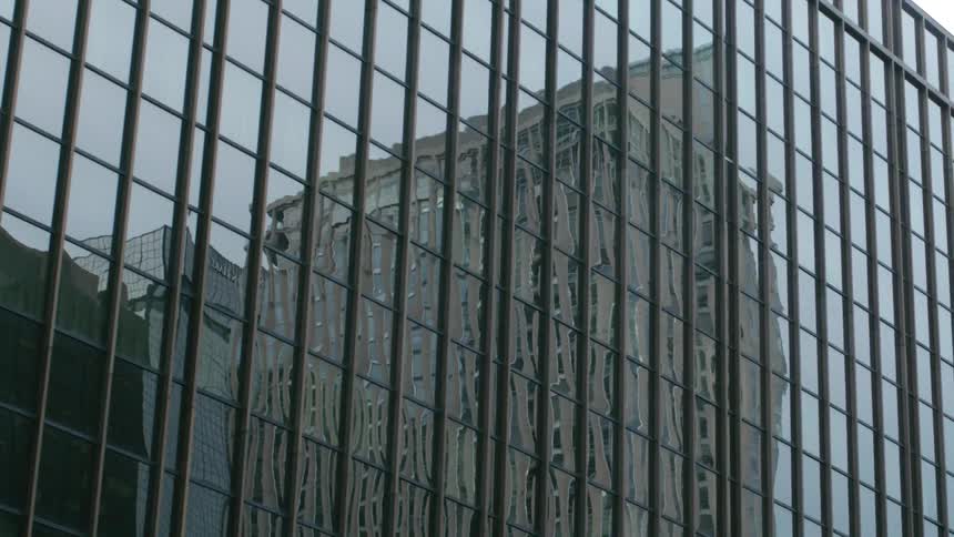 Close up view of a skyscraper in a city is displayed