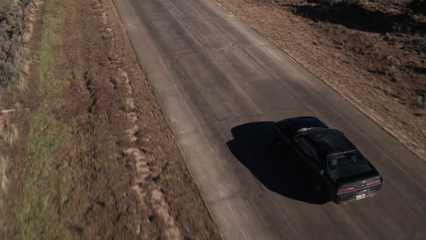 A car drives down a road below