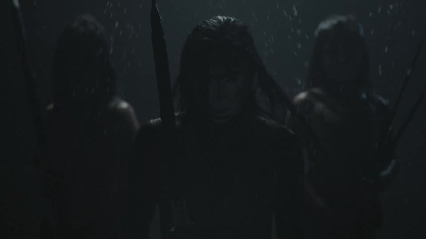 Men carrying spears are standing in the snow and looking forward