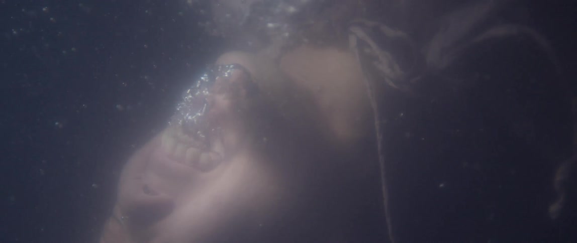 Air coming out of the mouth of someone held under water