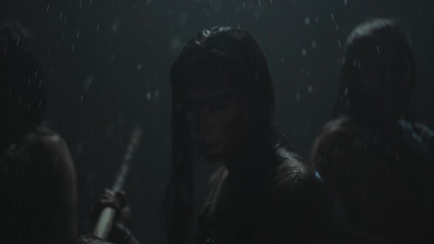 Three women warriors stand in fighting stances on a rainy night