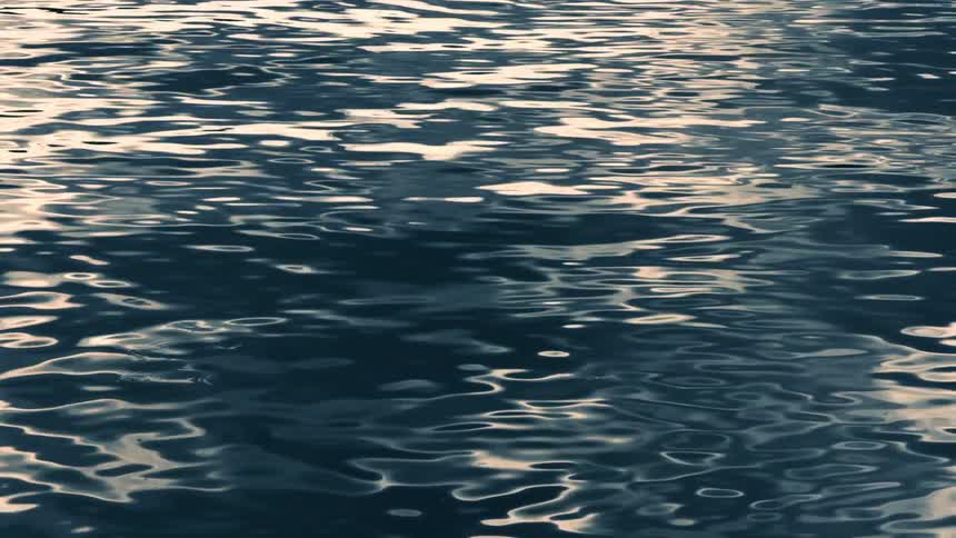 Sunlight reflects on the water as it ripples and waves