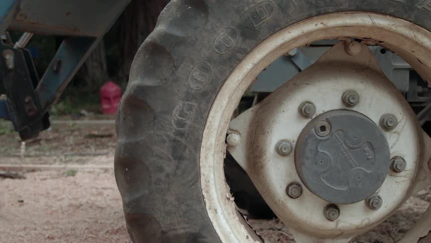 A big rubber tire of heavy machinery rolling over dirt