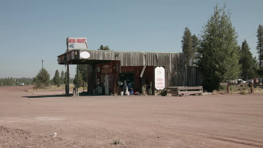 A store sits along a dirt road