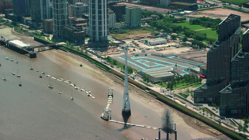 An aerial of a coastline with tall buildings built near with elaborate architecture