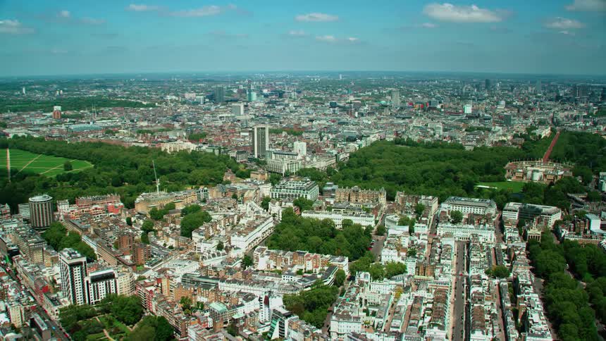 Aerial view of the parks and greenery on a city extending to the horizon at daytime
