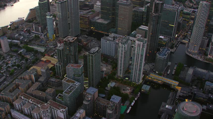 A downtown with many skyscrapers near the waters edge is seen from above