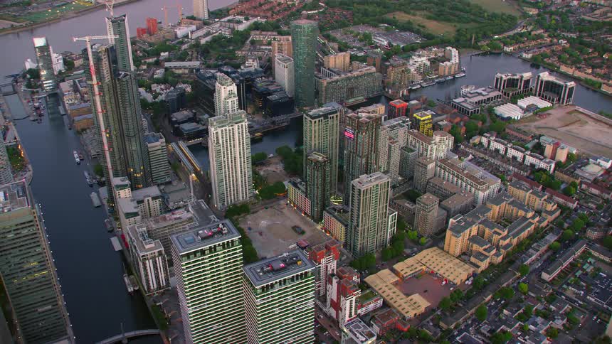 Construction cranes work on multiple downtown skyscrapers near river