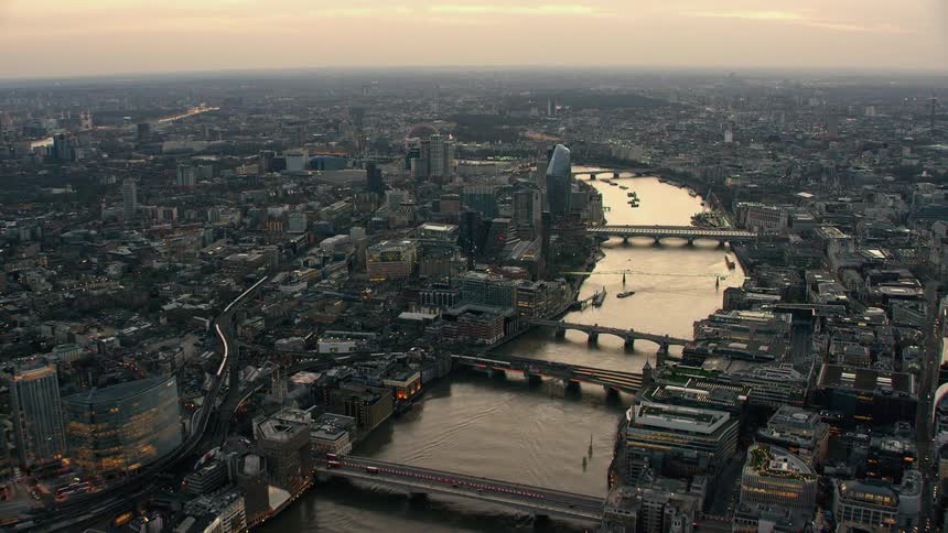 A river winding through a metropolis in the evening