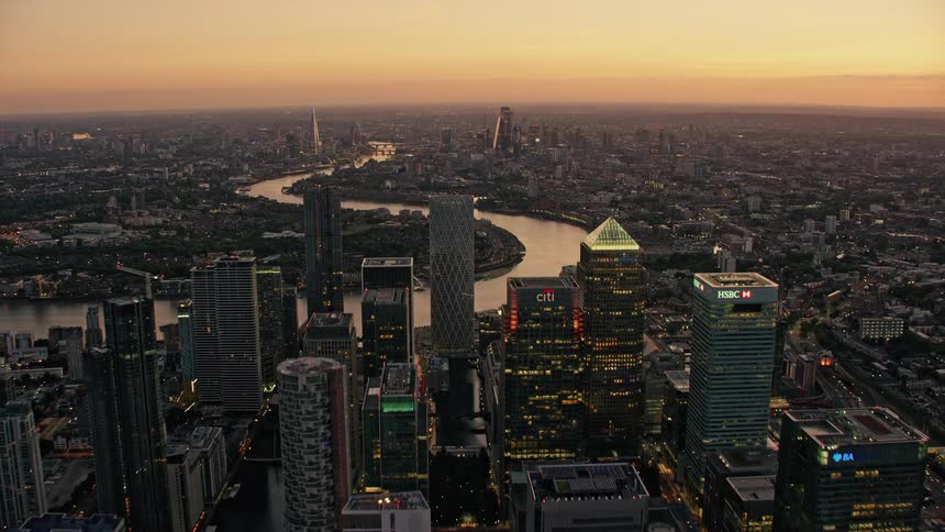 A winding river through a metropolis at sunset